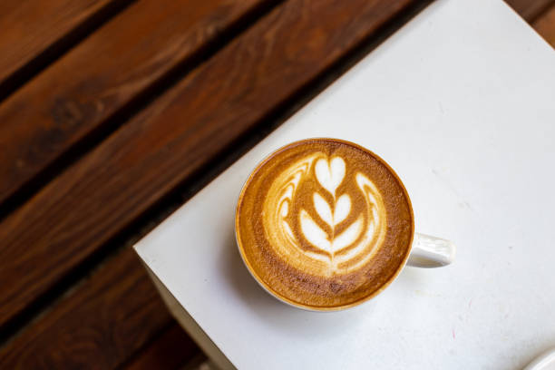 istock white cup of cappuccino with latte art on white table 1411211837