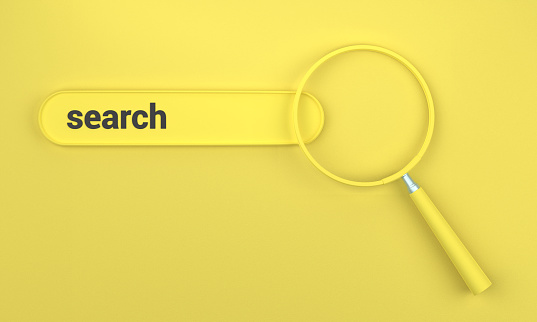 Searching in search bar with magnifying glass. SEO concept on yellow background.