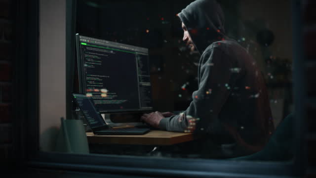 Hacker Using Desktop Computer to Perpetuate Cyber Attack, Doing DDOS Attack, Sends Viruses, Phishing Software, Malware, Stealing Private Data, Credit Card Fraud. Shot into City Apartment Window.