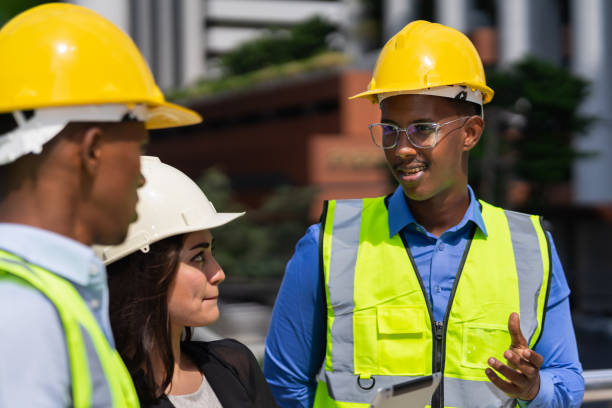 istock black executive engineer wear helmet working at construction site outside building in city and looking at caucasian businesswoman and black engineer 1411214764