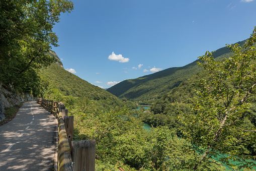 panoramic view of the bicycle lane that link Nova Gorica to the various towns along the river Isonzo in the Slovenian country, surrounded by beautiful green vegetation in summer