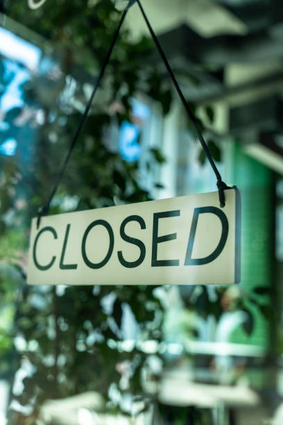 istock Board with information notice on front door of restaurant that says Closed. 1411216630