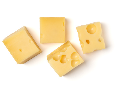 maasdam cheese cubes isolated on white background close up, top view