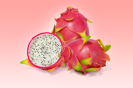 Dragon fruit, red-green peel fruit isolated on a light red background