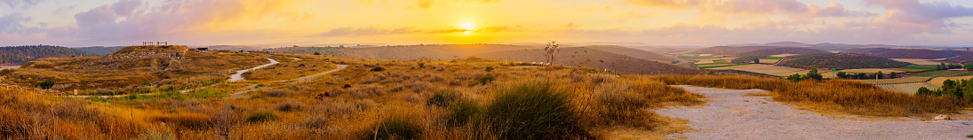 Sunrise panorama of the ancient ruins of Tel Lachish, countryside and rolling hills in the Shephelah region, south-central Israel