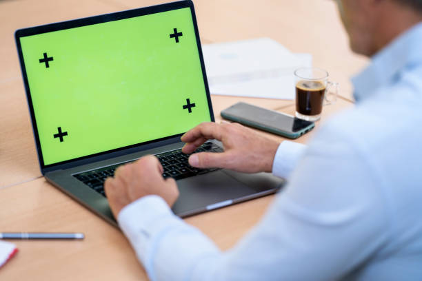 istock Mid shot sideview of mature businessman typing on laptop computer 1411220939