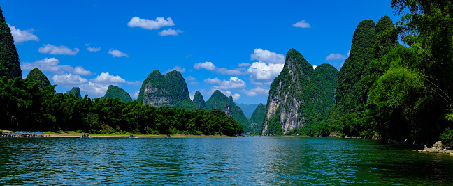 View of Ha Long Bay, Quang Ninh province, Vietnam; with a lot of limestone islets and cruise ships; on a blue sky summer day.  Travel and landscape concept.