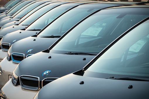 Hamburg, Germany - July25. 2022: 
A row of used BMW i3 cars at a public car dealership on the outskirts of Hamburg. The BMW i3 is an electric car or plug-in hybrid vehicle from the automobile manufacturer BMW in the small car class