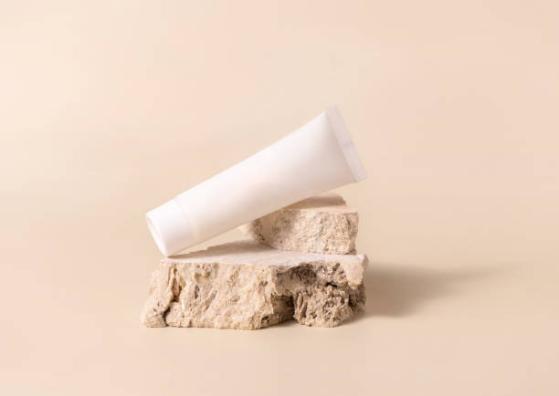 istock White plastic cream tube on stone on light yellow close up, Mockup 1411230722