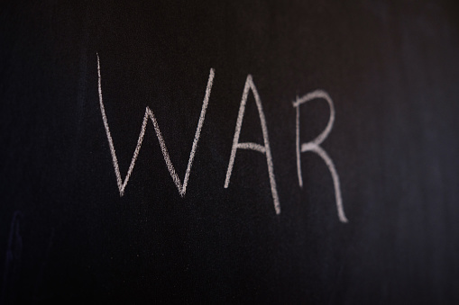 Slate writing board with the word war written