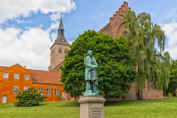 Photo of Monument for Hans Christian Andersen with Odense cathedral in background