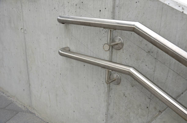 istock a staircase with concrete sides at a public building. the safe staircase has two handrails, one with a reduced height for children under 12 at the entrance to the school 1411236713