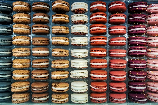 Multicolored Macarons - delicious French pastries, made of eggs white, almond, and sugar cookies with cream or fruit filling.