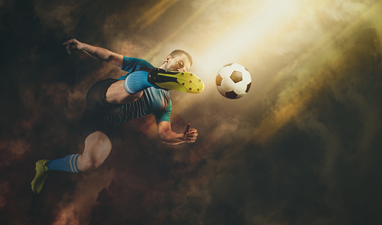 Soccer player in action on smoke background
