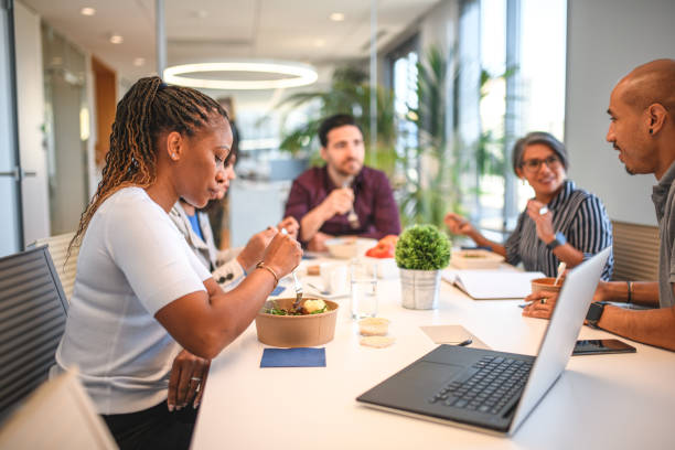 istock Multiracial Business Employees Talking while Having Lunch Indoors 1411238313