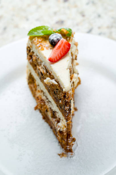 istock Carrot cake on a white plate macro close up selective focus 1411238423