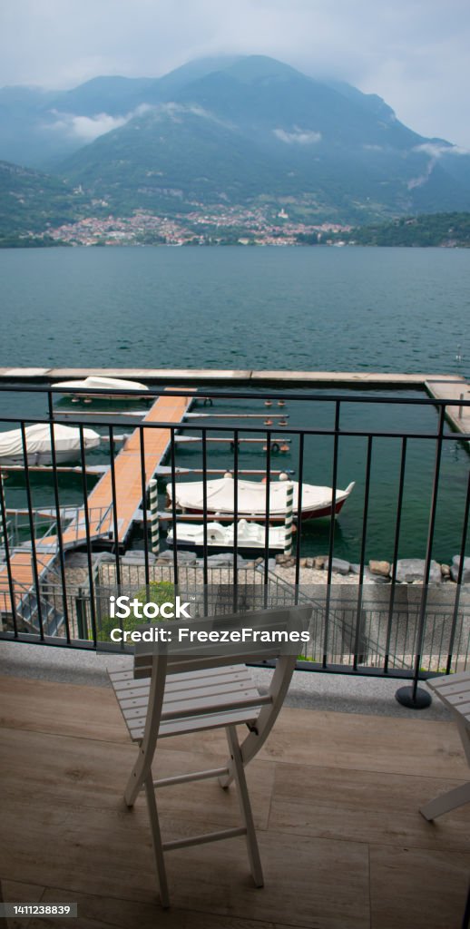 Boats and Boat dock on Lake Como, Italy from the town of Lezzeno- Varenna, Lombardy region, Europe, Alps Lake Como, Italy from the town of Lezzeno- Varenna, Lombardy region, Europe, Alps Architectural Dome Stock Photo