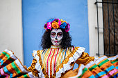 Portrait of a mid adult woman dancing and celebrating the day of the dead