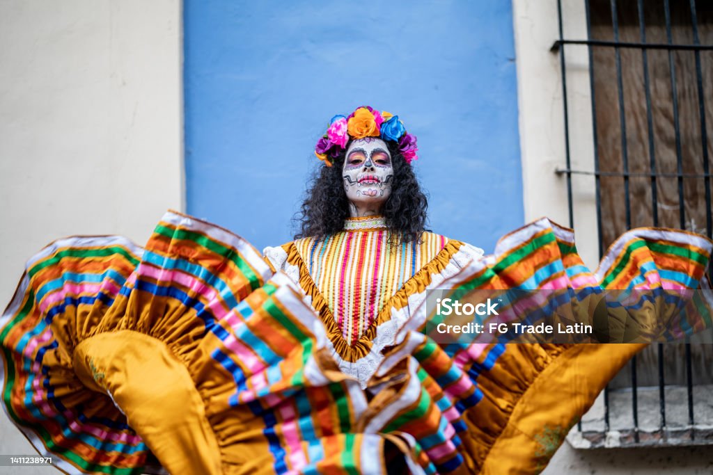 Portrait of a mid adult woman dancing and celebrating the day of the dead Day Of The Dead Stock Photo