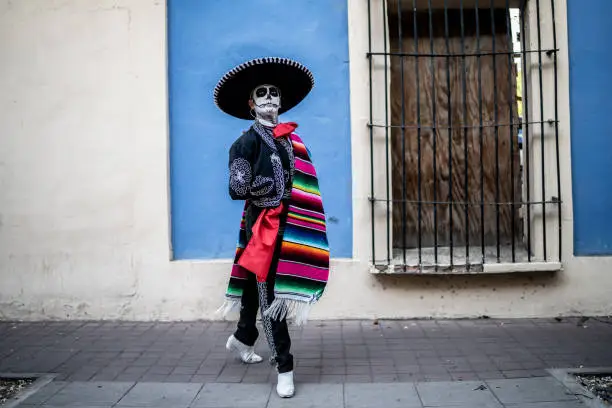 Young man dancing and celebrating the day of the dead