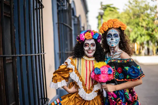 Portrait of a female friends celebrating the day of the dead outdoors