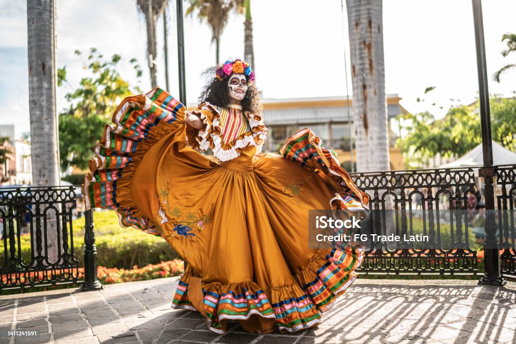 Mid adult woman dancing and celebrating the day of the dead Mexico Stock Photo