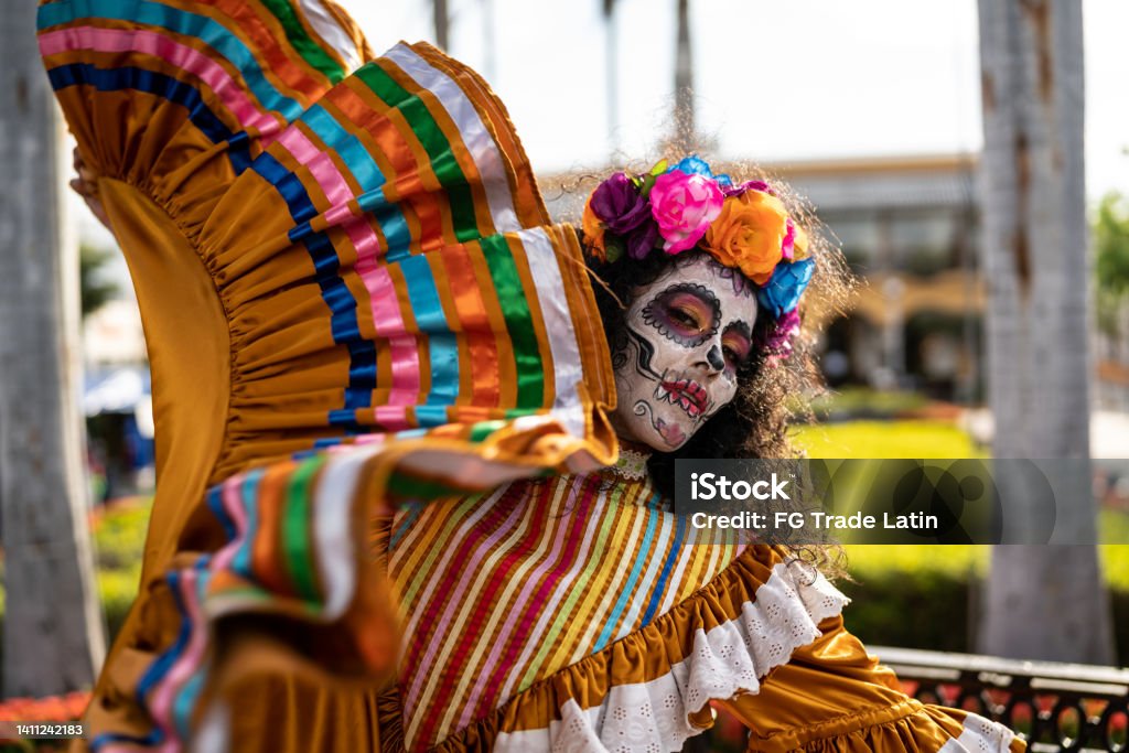 Mid adult woman dancing and celebrating the day of the dead Day Of The Dead Stock Photo