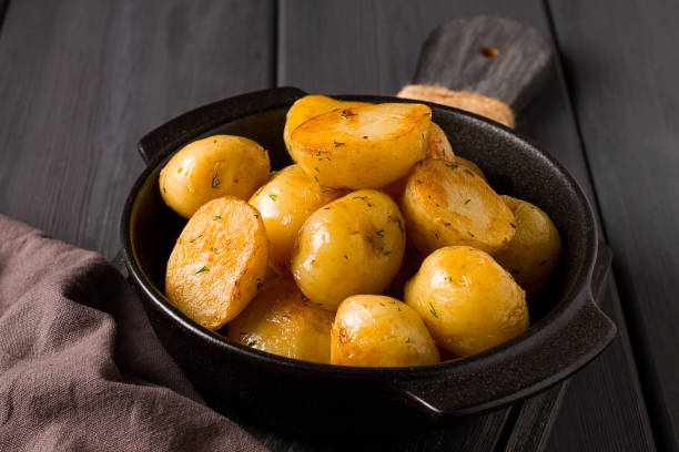 istock Fresh Cooked, new potatoes,with dill, on a wooden table, selective focus. close-up, toning, no people, 1411242608