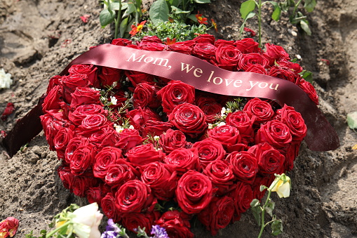 beautiful red bouquet of roses in cemetery