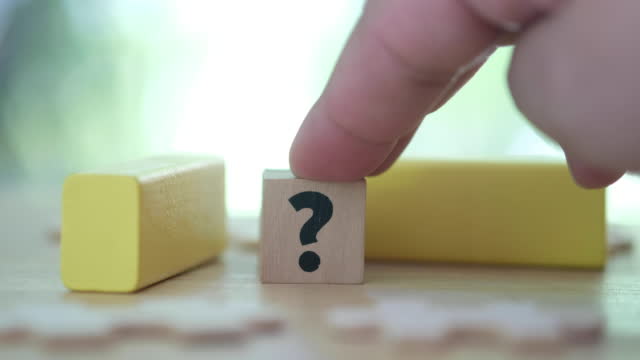 Customer with question mark. Support concept. Wooden cube with icon question mark