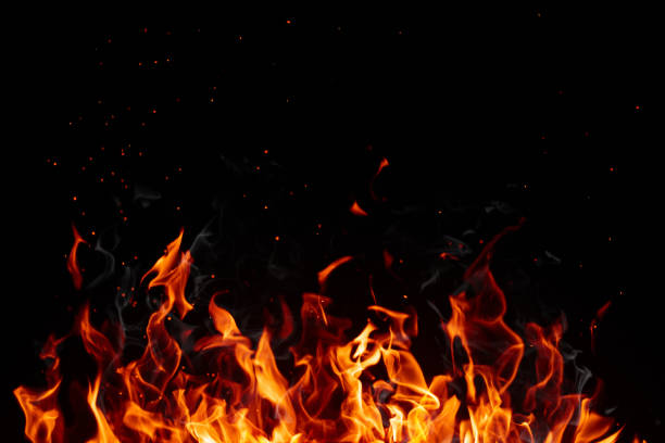 istock Blazing flame of fire with bright sparks isolated on black background 1411245463