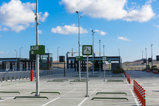 Reserved parking space with wheelchair signs at Istanbul Airport outdoor parking lot, Turkiye