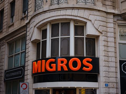 Basel, Switzerland - July 4 2022: entrance to Migros supermarket in Basel. Migros is Switzerland's largest retail company.