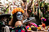 Portrait of a young woman celebrating the day of the dead at bar