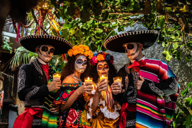Friends celebrating the day of the dead lighting candle