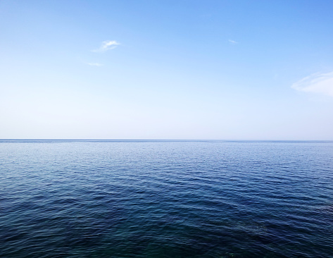 White foam waves on the turquoise sea and blue sky. The concept of ocean recreation