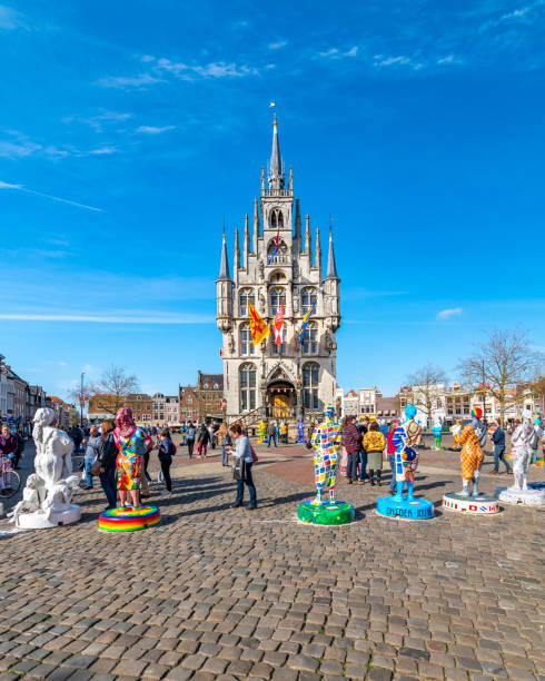 Gouda, Netherlands - 14.4.2022: Gouda main square and town hall. Blue sky, spring weather.