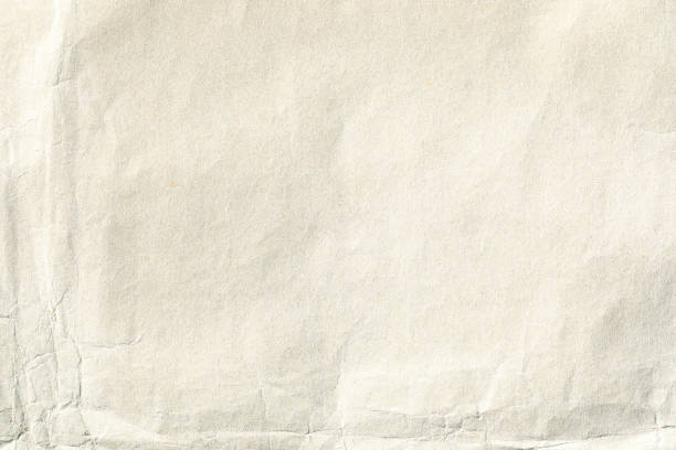 istock light yellow crumpled paper background texture 1411250812