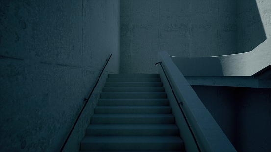 Scary, but beautiful white staircase in darkness from the bottom of the stairs. White staircase. White modern building staircase in a shadow