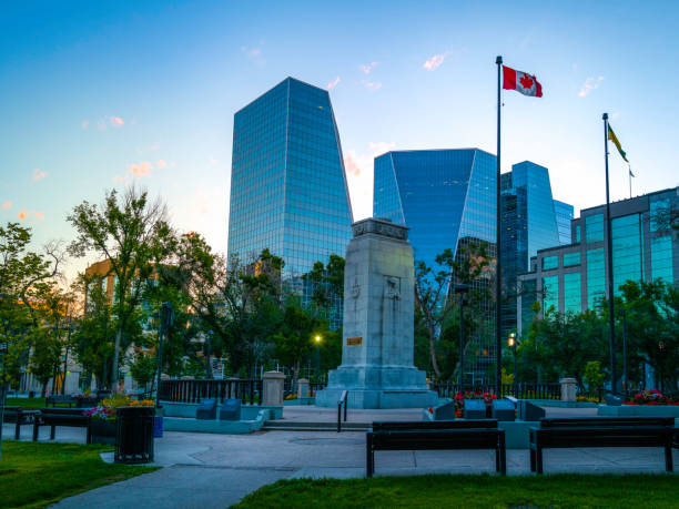 Skyline and Cityscape of Regina at dawn, the capital city of the Canadian Province of Saskatchewan. Victoria park's morning landscape with the Canadian flag waving over the fall buildings Cityscape at twilight in Regina, Saskatchewan, Canada regina stock pictures, royalty-free photos & images