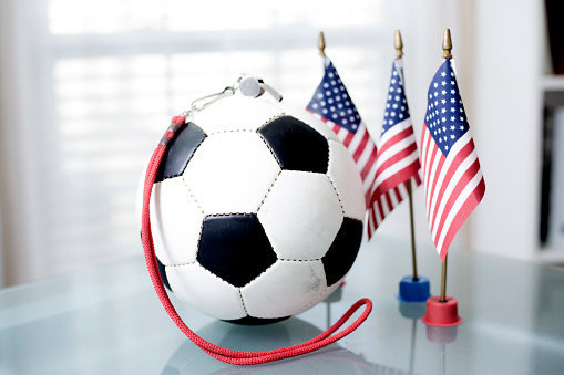 Soccer Ball on desk next to three small American flags
