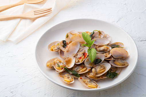 Stir Fried Clams with Roasted Chili paste in white plate