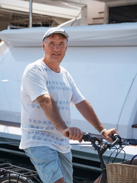 istock Portrait of confident man standing with bicycle 1411259371
