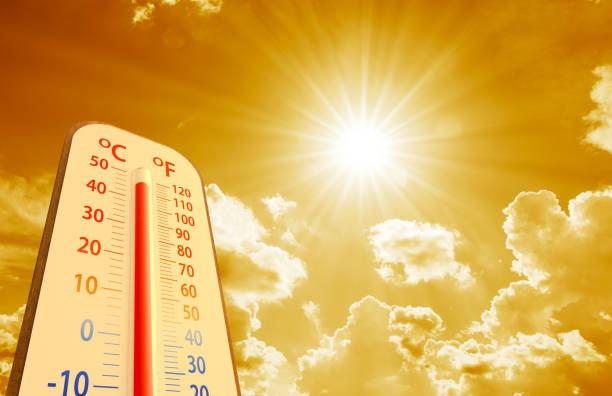 istock hot temperature,Thermometer on yellow sky with sun shining 1411260371