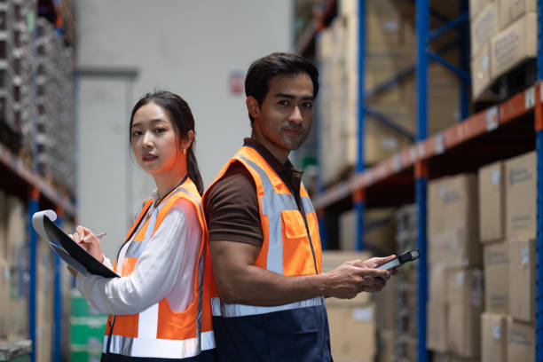 istock Warehouse worker and manager checks stock and inventory with digital tablet computer in the retail warehouse full of shelves with goods. Working in logistics, Distribution center. 1411261522