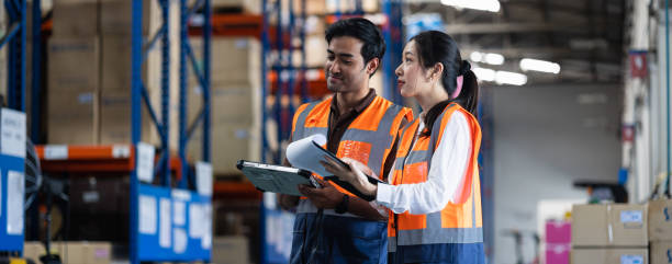 istock Panoramic warehouse worker and manager checks stock and inventory with digital tablet computer in the retail warehouse full of shelves with goods. Working in logistics, Distribution center. 1411261766