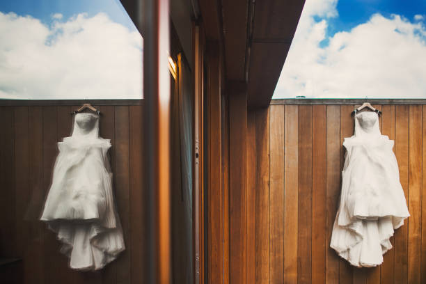 istock Wedding dress hanging on a wooden wall 1411261880