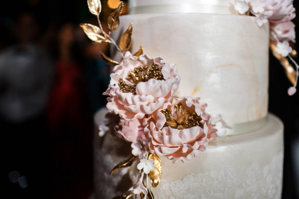 istock Multilevel wedding cake decorated with pink flowers 1411261905