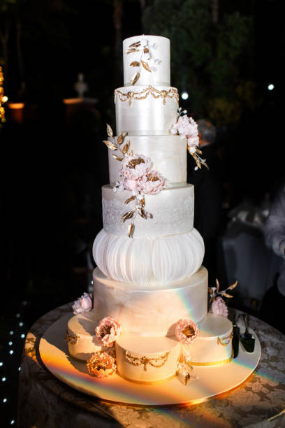 istock Multilevel wedding cake decorated with pink flowers 1411261906