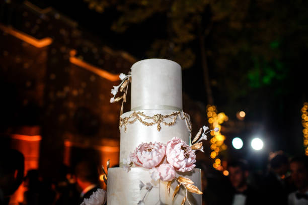 istock Multilevel wedding cake decorated with pink flowers 1411261911